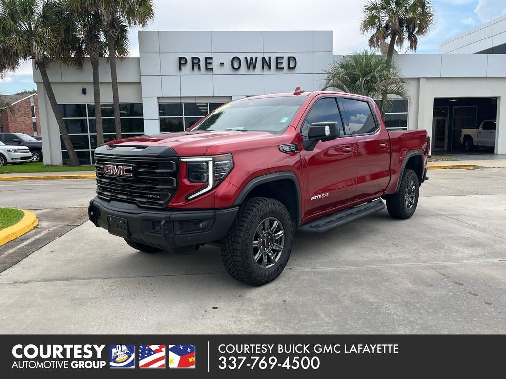 2025 GMC Sierra 1500 AT4X in Volcanic Red Tintcoat — front three-quarter view
